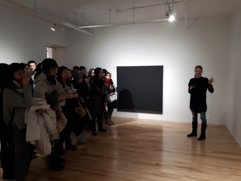 Assistant Art Appraiser Erika Del Vecchio presenting abstract painter Richard Mill at Galerie Trois Points to foreign students attending Michelle Sullivan's Current Trends in Digital Communication course at McGill University
